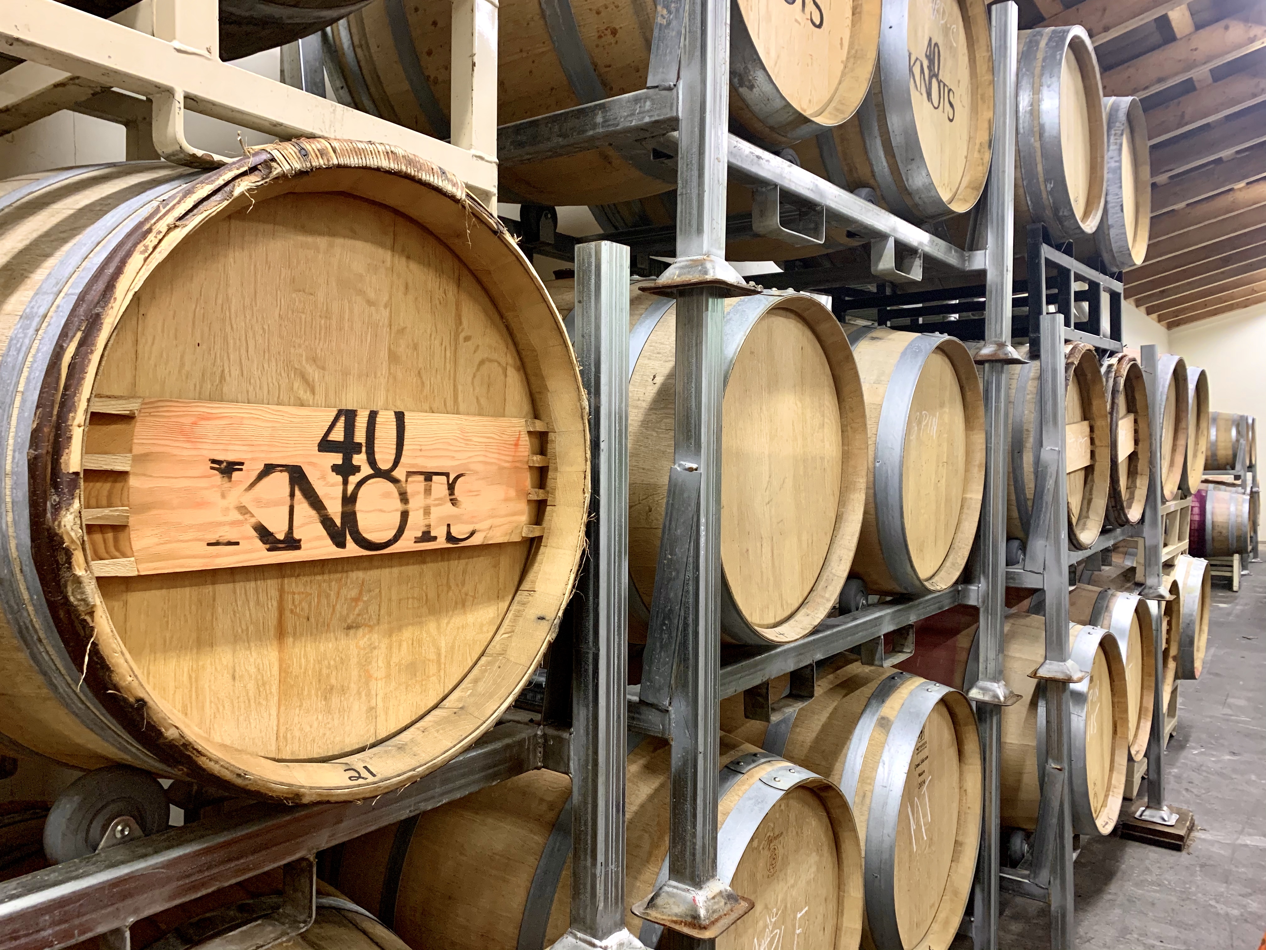 image of rows 40 Knots wine casks in the wine cellar