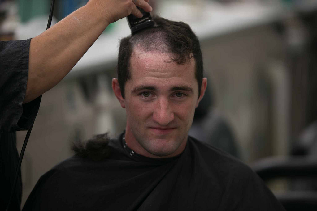 image of man getting hair cut with electric clippers