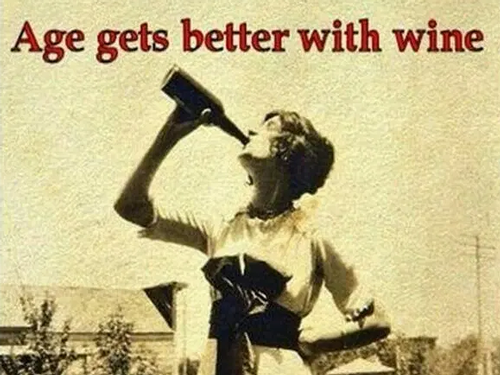 Image of woman drinking wine from bottle.
