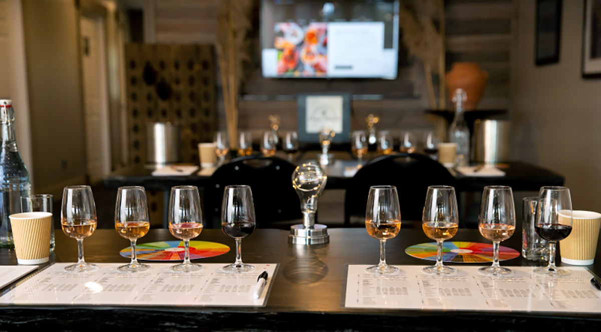 Image of tables with wine bottle setup for wine class.