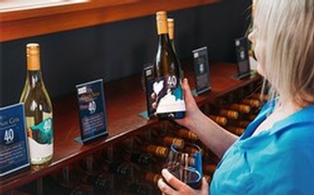 Woman looking at bottles of 40 Knots wines