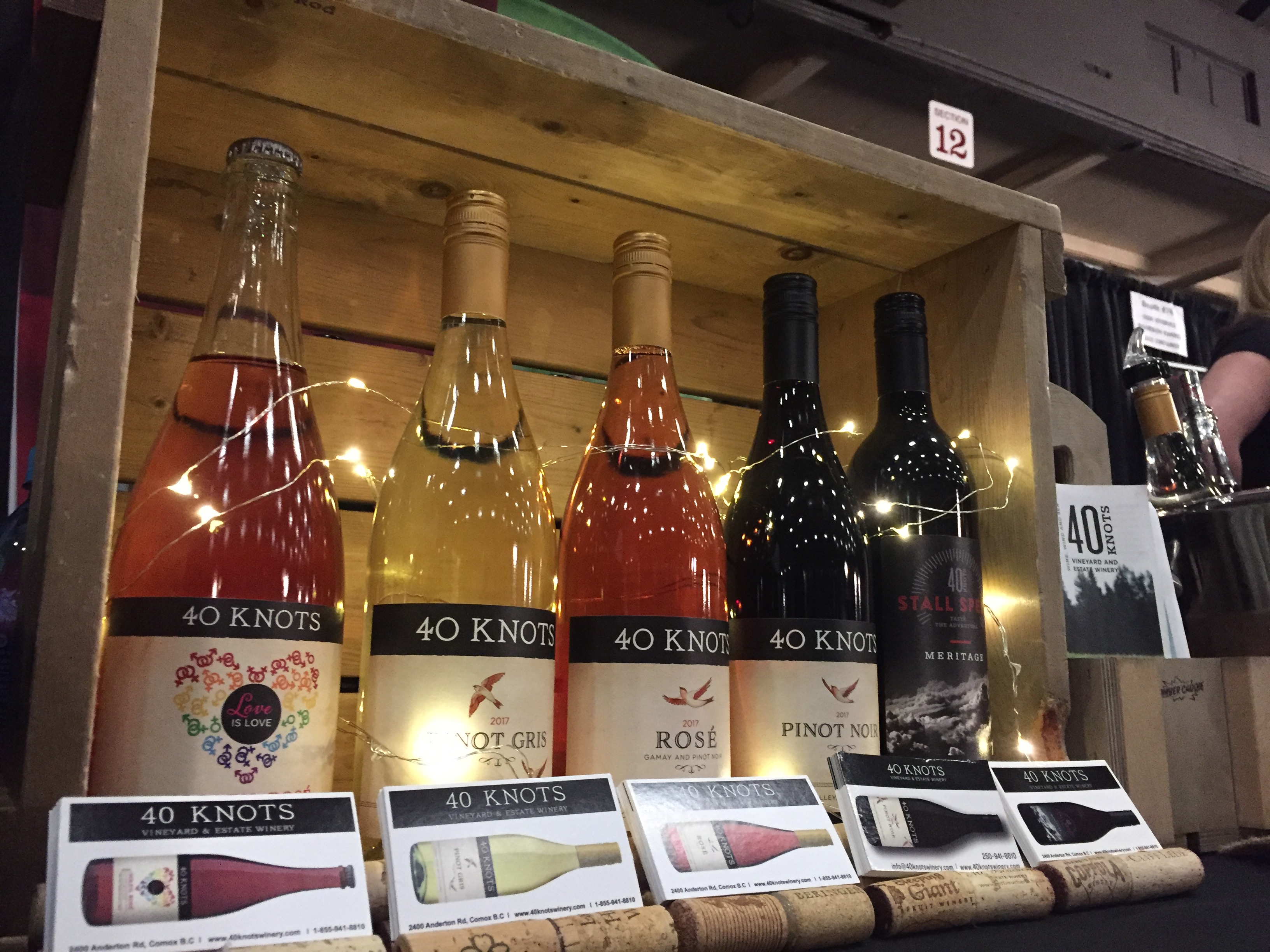 Image of a display rack containing four 40 Knots wine bottles.