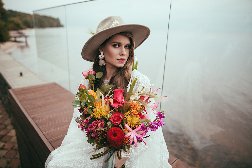 Image of attractive woman in bohemian wedding dress and hat.