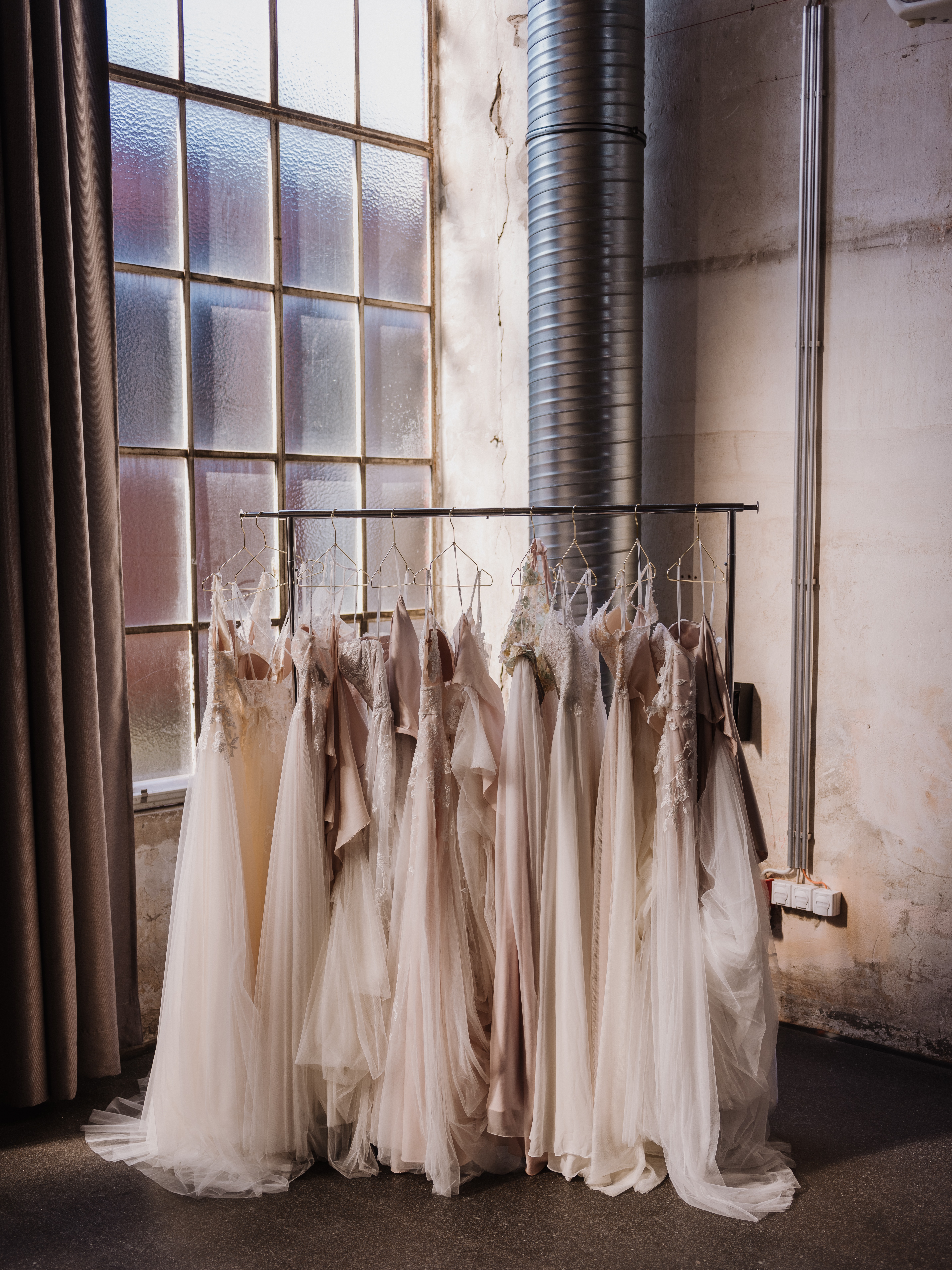 image of bridal gowns hanging on a rack