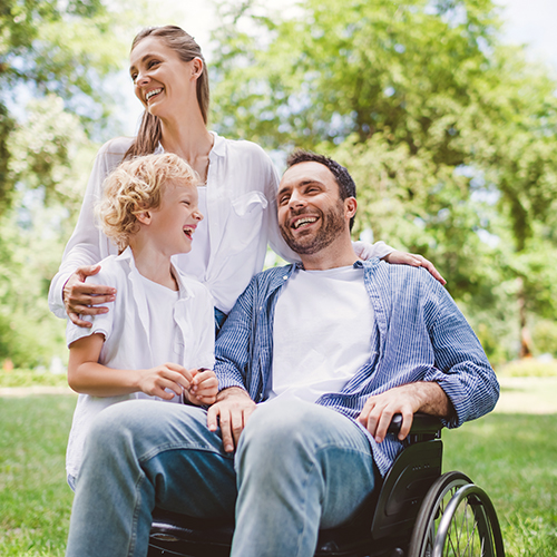 Image of happy family with disabled father on wheelchair