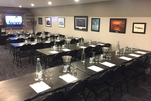image of classroom setup with desks that are setup with wine tasting equipment.